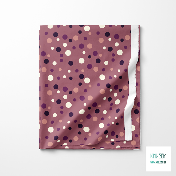 Random pink, purple and cream polka dots fabric