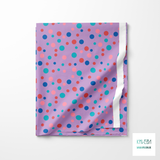 Random pink, red, blue and teal polka dots fabric