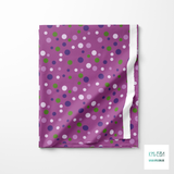 Random purple and green polka dots fabric