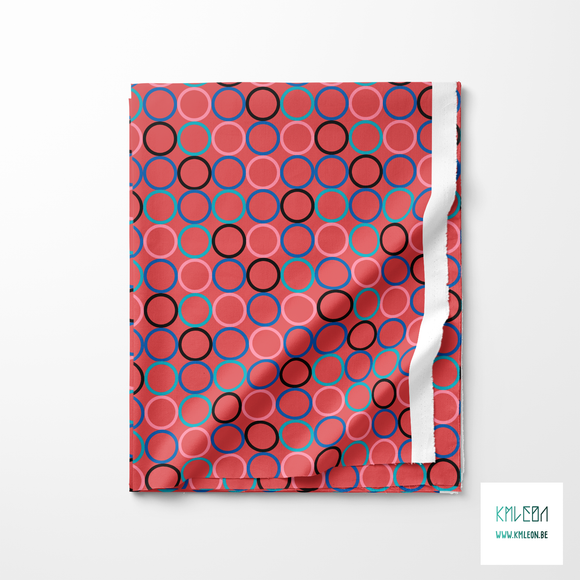 Random teal, pink, blue and black circles fabric