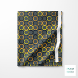 Random orange, yellow, dark teal and black circles fabric