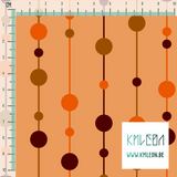 Brown and orange pearls on strings fabric