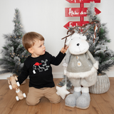 Blonde boy playing in front of christmas tree, wearing black shirt with long sleeves, with dino 'Fla La La Rawr Rawr Rawr' shirt by KMLeon.