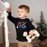 Blonde boy with wooden toy, wearing black shirt with long sleeves, with dino 'Fla La La Rawr Rawr Rawr' shirt by KMLeon.