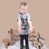 Blonde boy playing with snow, wearing heather grey shirt with 'Waiting for snow' print by KMLeon.