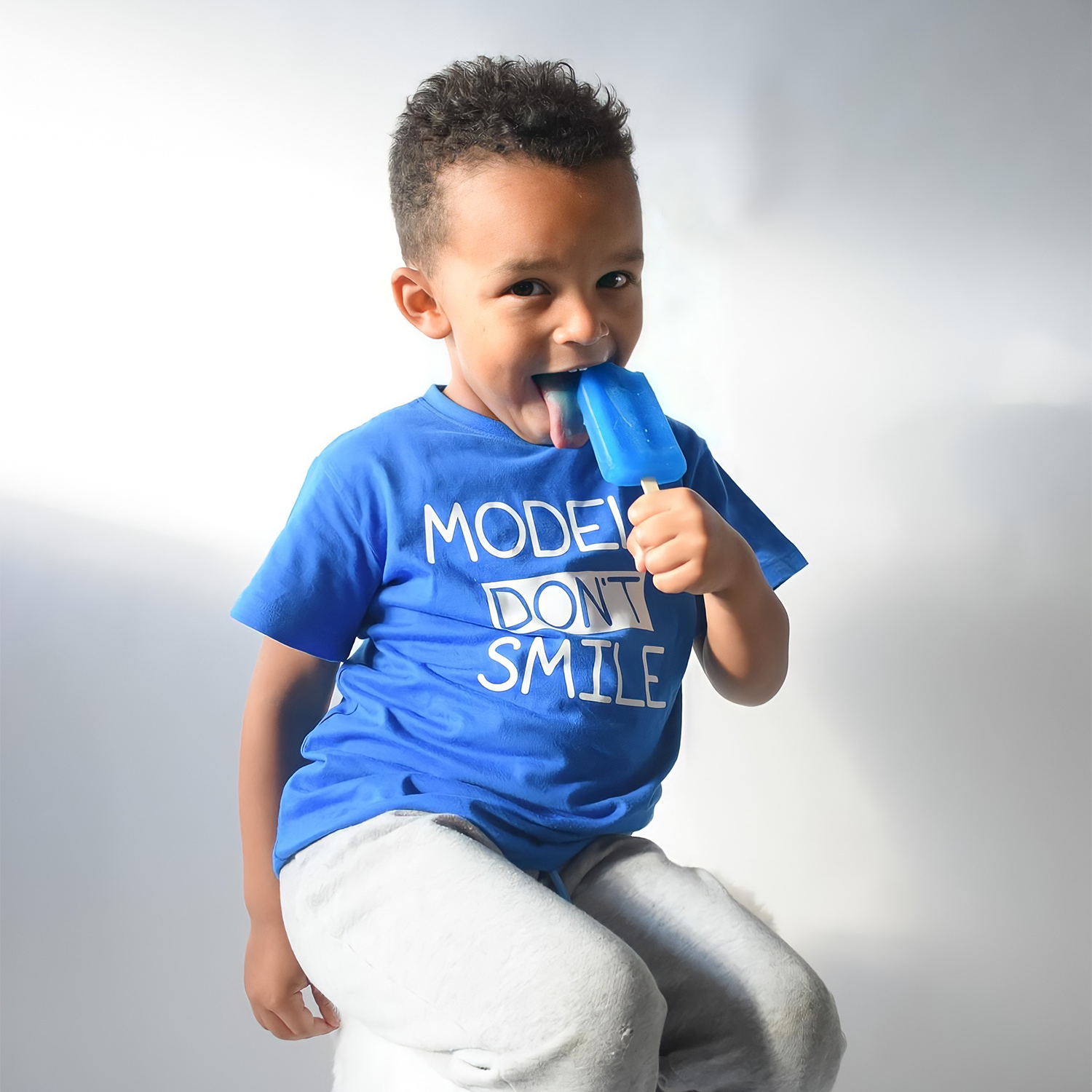 'Models don't smile' kids shortsleeve shirt