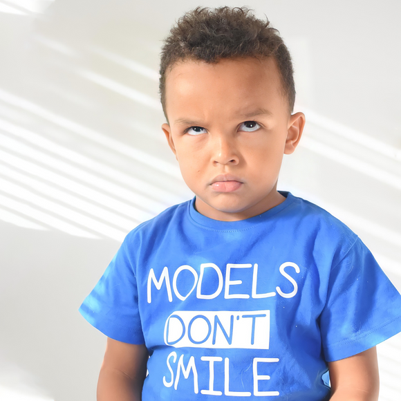 'Models don't smile' kids shortsleeve shirt