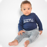 Black boy sitting wearing navy shirt with longs sleeves with 'I'm having a meltdown' print by KMLeon.