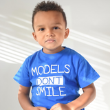 'Models don't smile' kids shortsleeve shirt