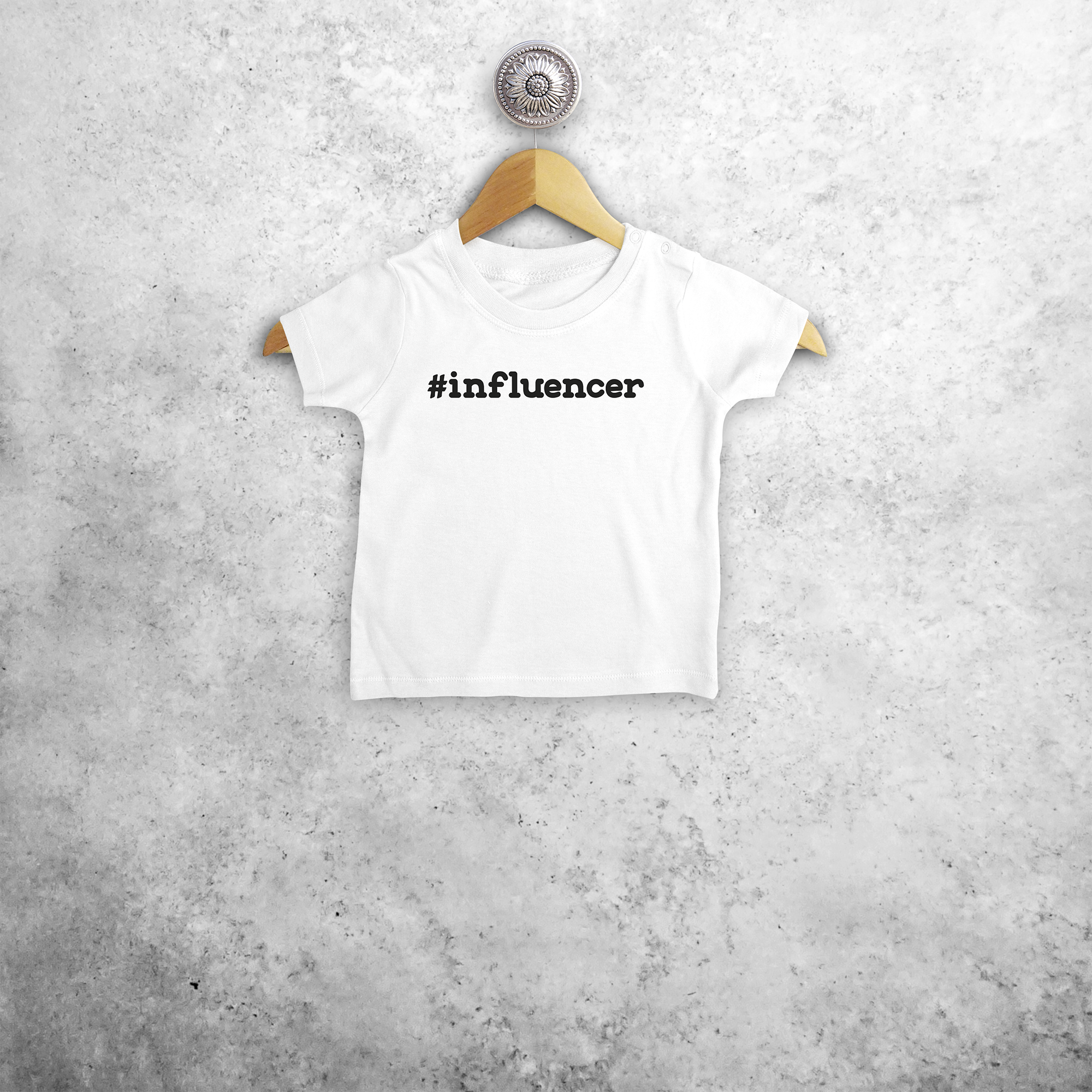 Baby or toddler shirt with short sleeves, with '#influencer' print by KMLeon.