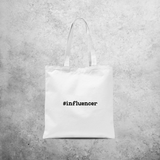 Tote bag, with '#influencer' print by KMLeon.