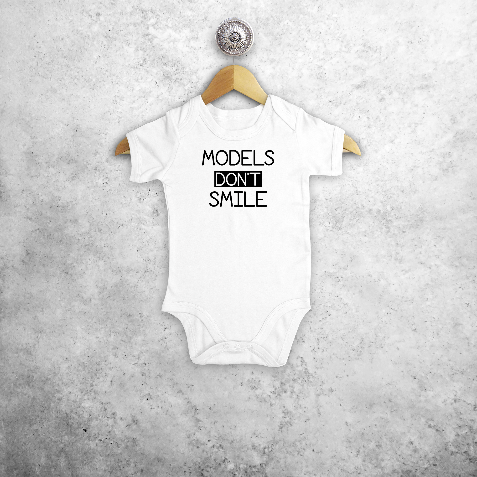 'Models don't smile' baby shortsleeve bodysuit